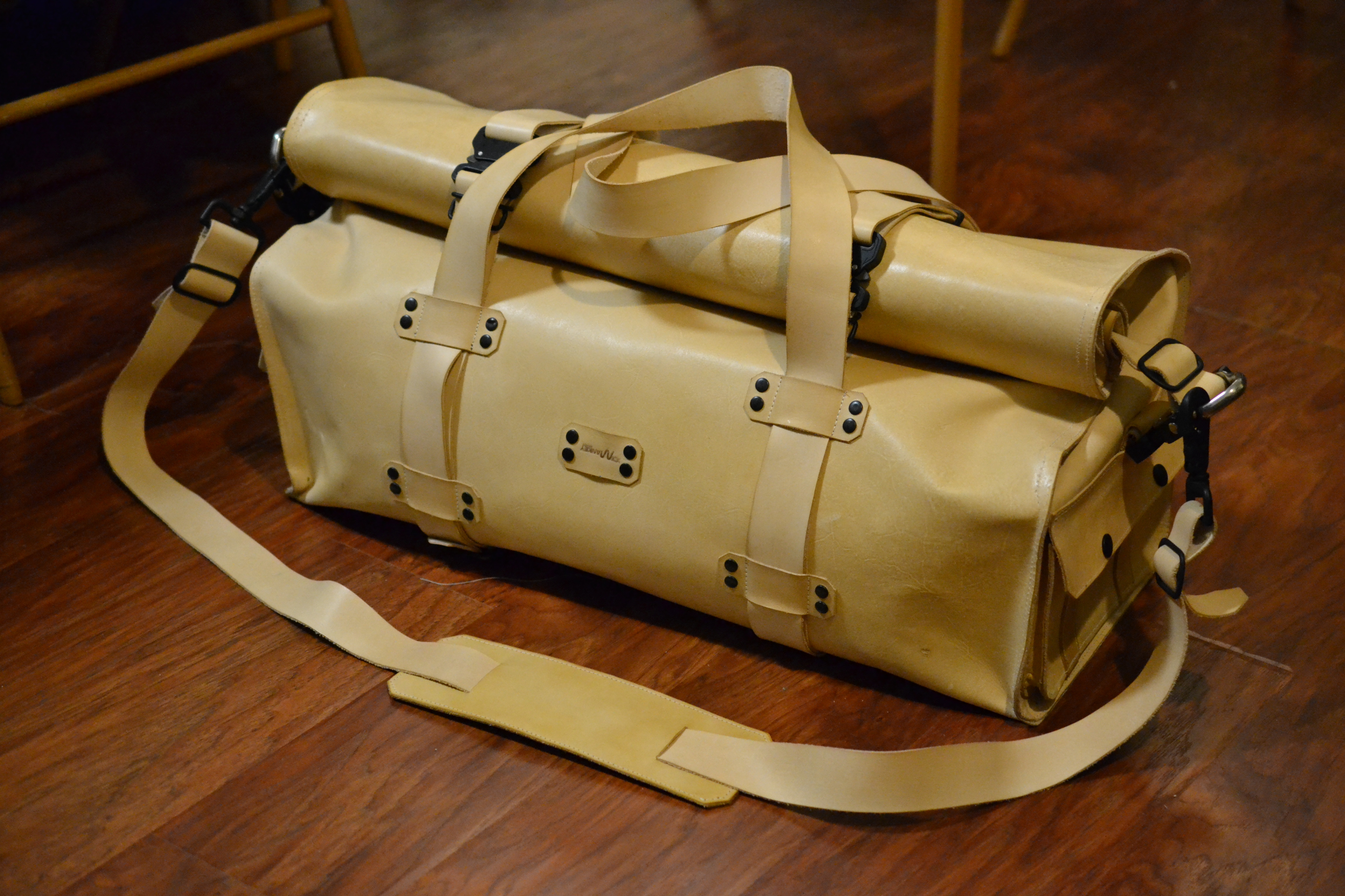 A Concept Depicting An Open Brown Leather Duffel Bag Revealing