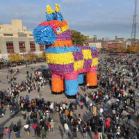 Giant pinata takes a wrecking ball to open it