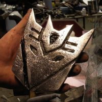 Sandcast aluminum Decepticon symbol