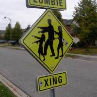 Zombie crossing road sign