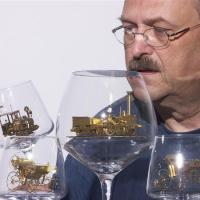 Tiny solar-powered brass engine in a wineglass