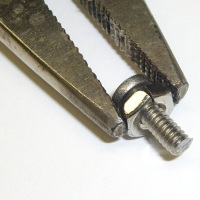 Holding round-head screws for trimming