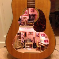 A Doll House Made From An Old Guitar