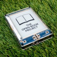 Open Book E-Reader set down on a grassy lawn