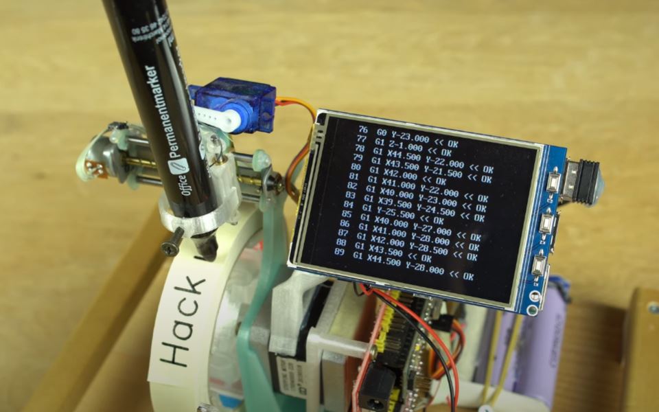 This little DIY plotter creates labels on tape