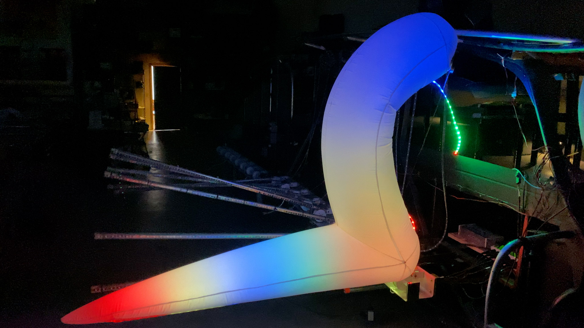 One rib glows red at the tip, followed by yellow, blue, orange, yellow, and blue again.